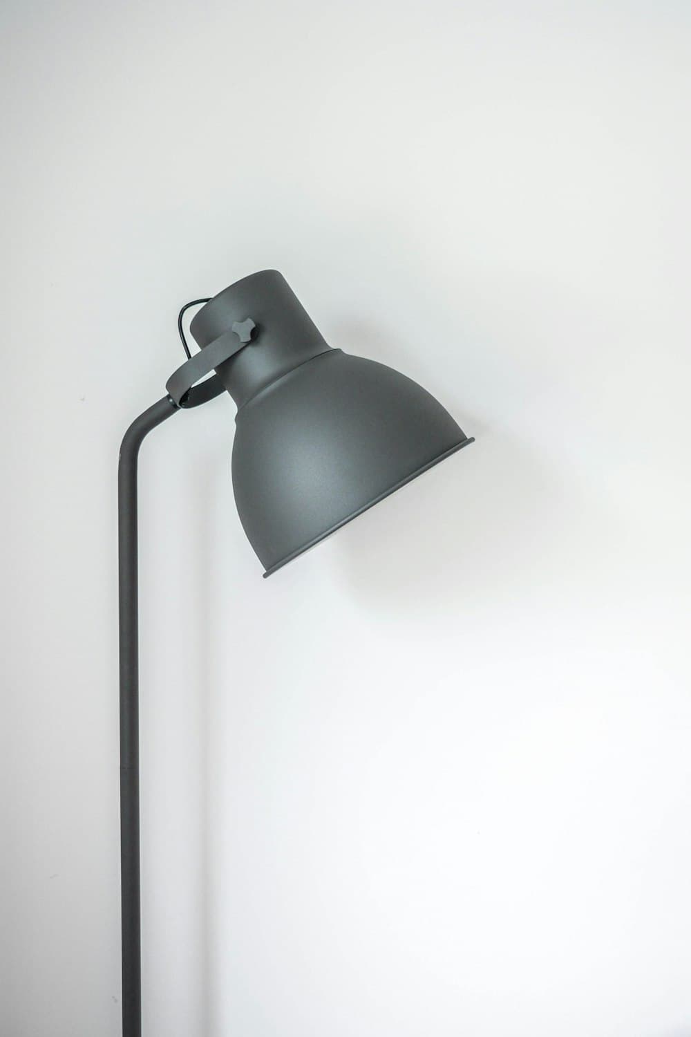Desk lamp casting warm task light across a workspace