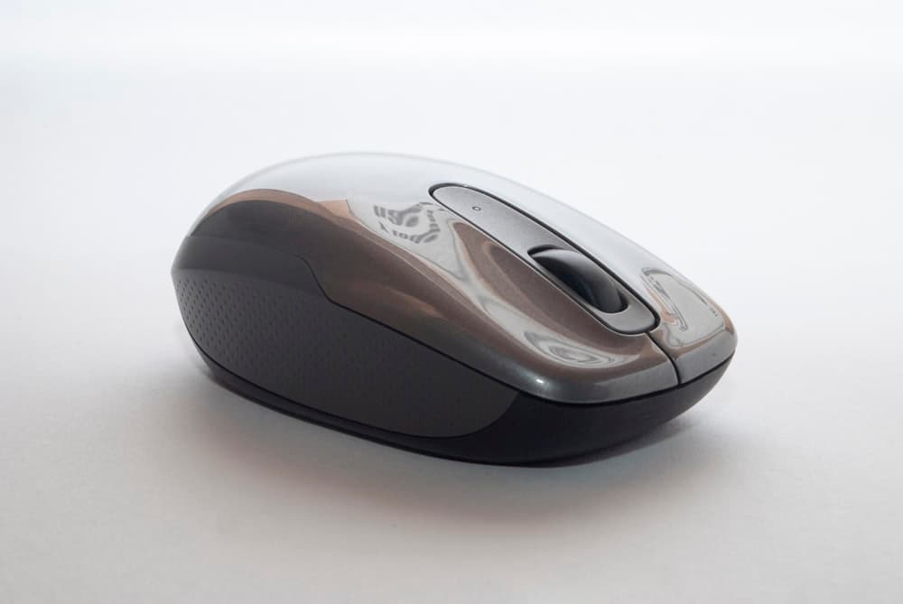 Ergonomic wireless mouse beside a keyboard